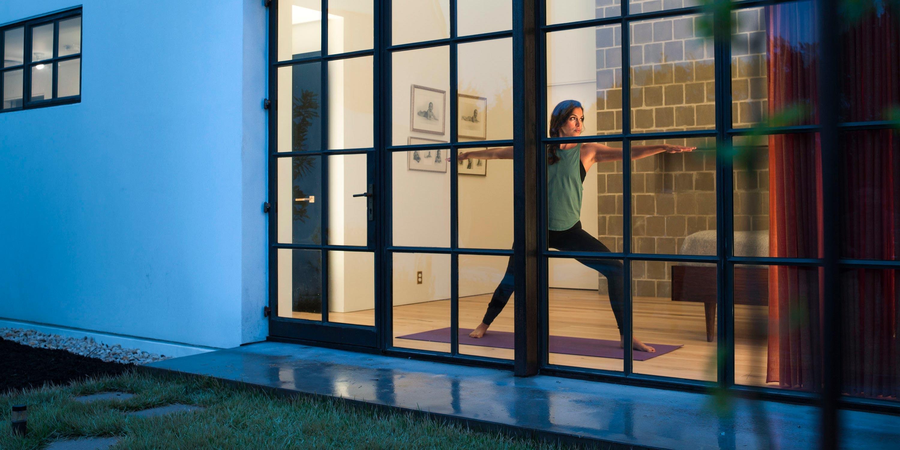Woman practicing yoga  inside a room