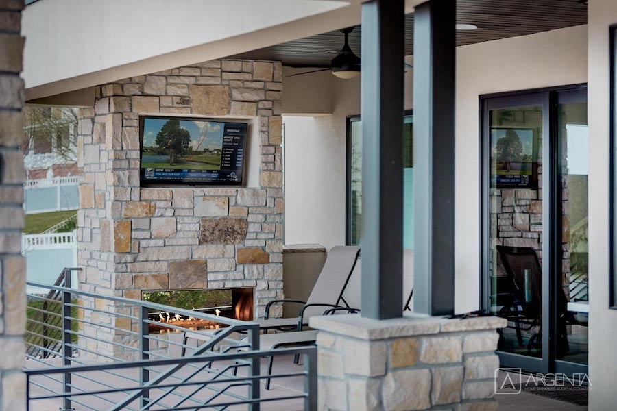 A wall-mounted TV on a patio. 