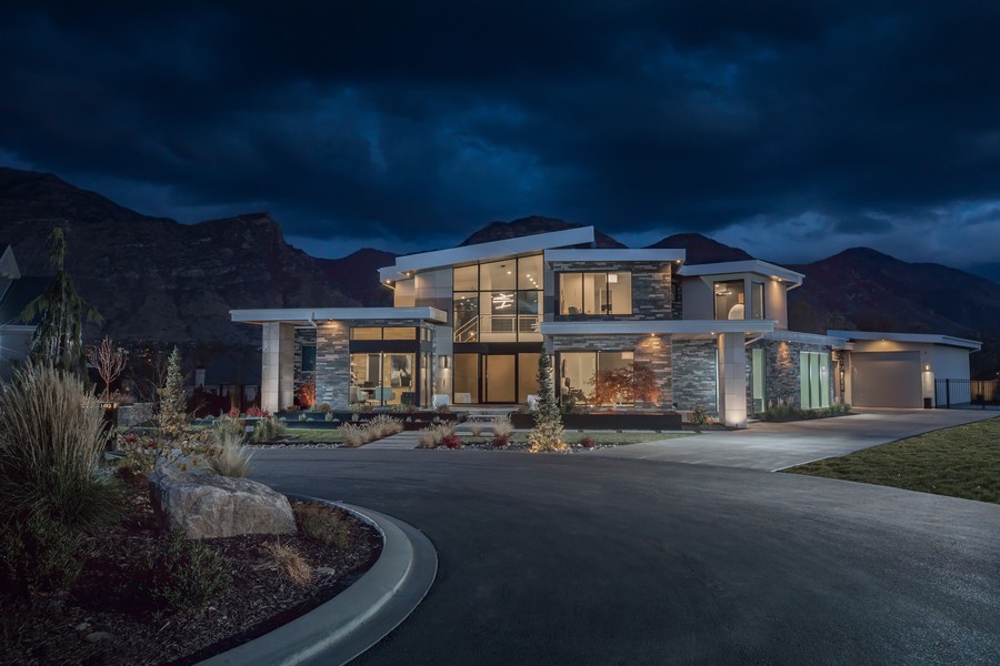 A two-story home illuminated inside and out with stunning lighting solutions that automatically turned on at dusk